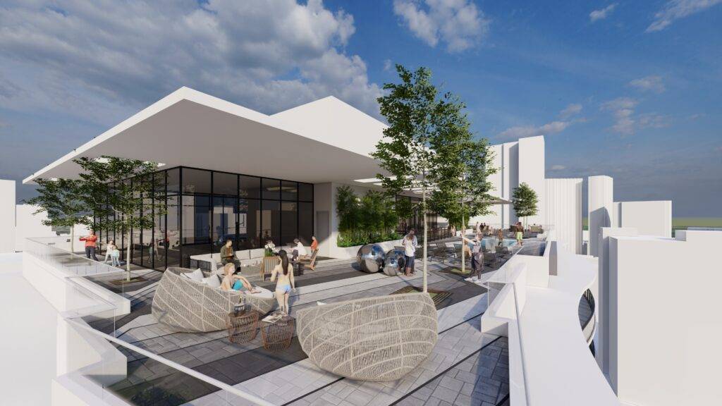 Modern rooftop terrace with lounge chairs and greenery under a clear blue sky.