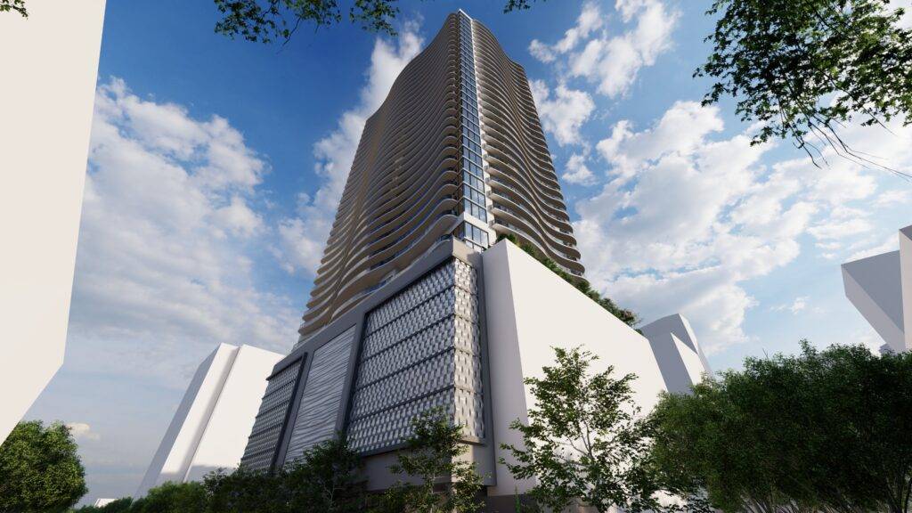 Skyscraper against a vibrant blue sky with clouds and surrounding greenery.