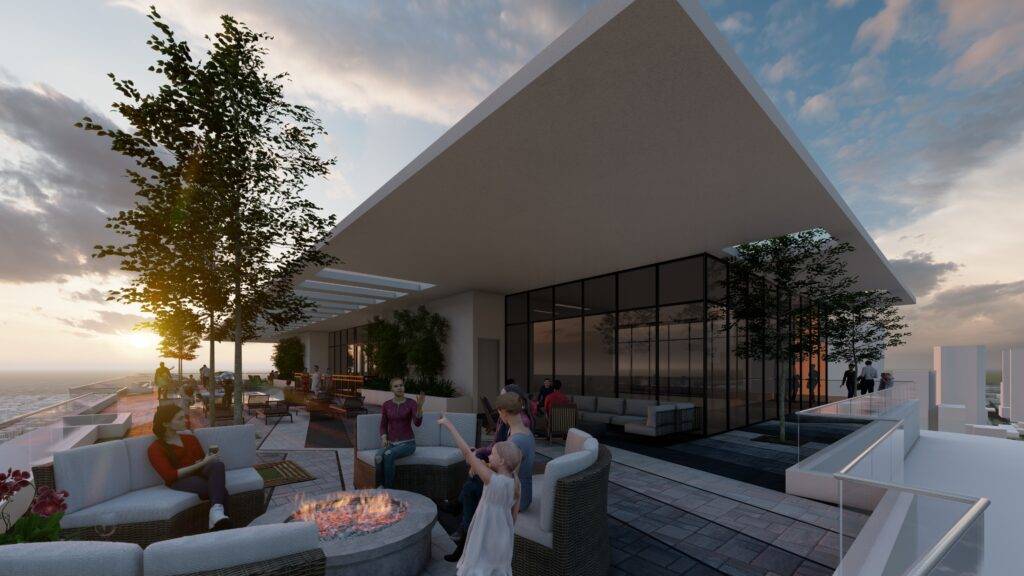 Modern rooftop with people relaxing around a fire pit under a sunset sky.