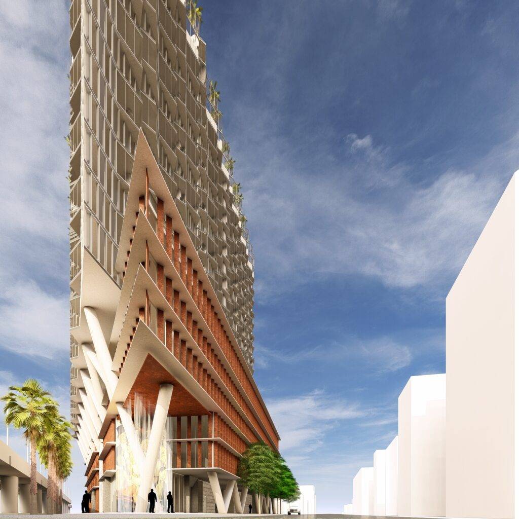 Innovative skyscraper design with unique geometric patterns under a clear blue sky.