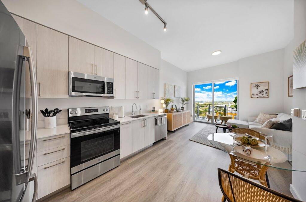 Modern kitchen and living area with sleek appliances and natural light.