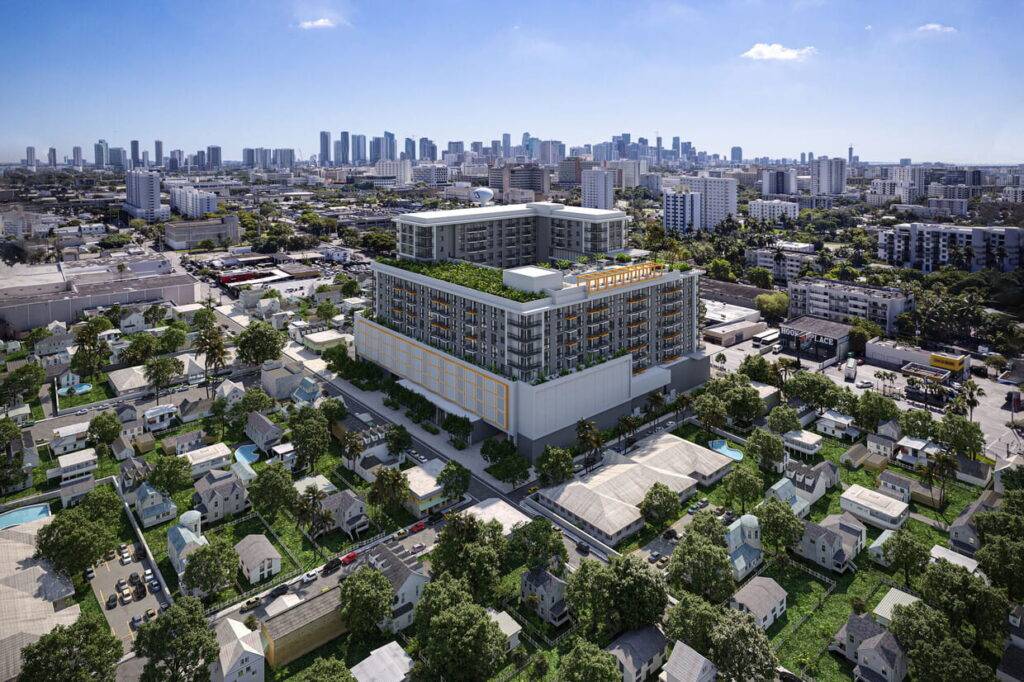 Aerial view of a modern urban development in a cityscape with skyscrapers in the background.