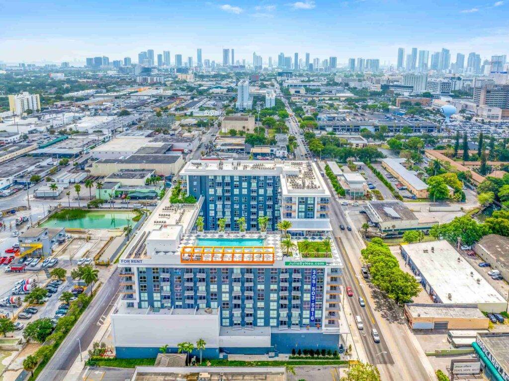 Aerial view of Allapattah neighborhood with modern buildings and city skyline in the distance.