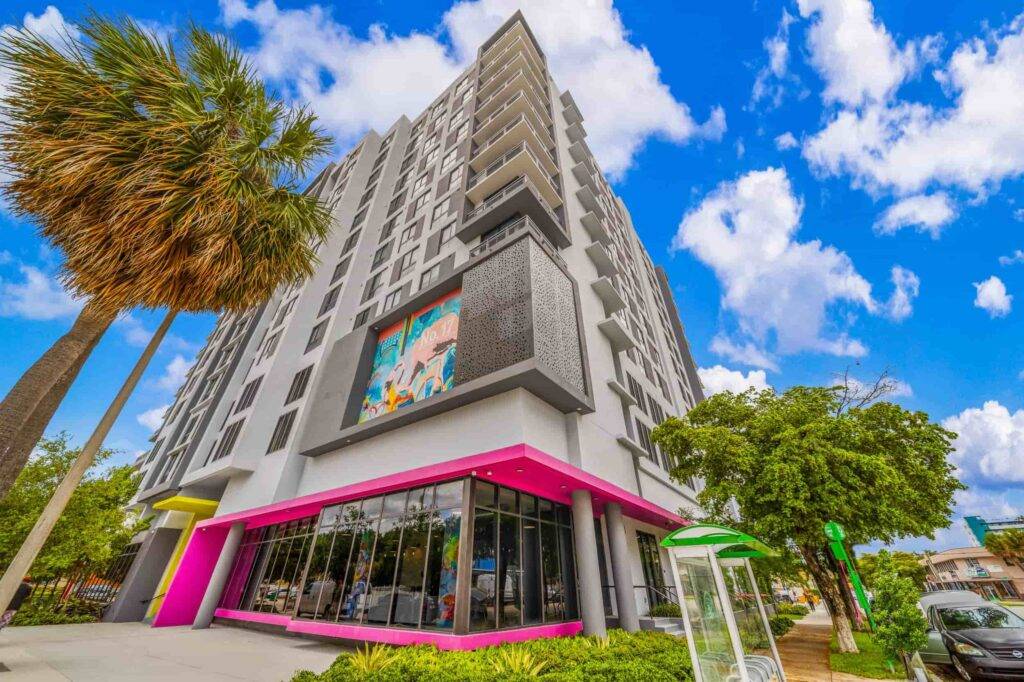 Modern urban building with vivid colors and lush greenery in Allapattah.