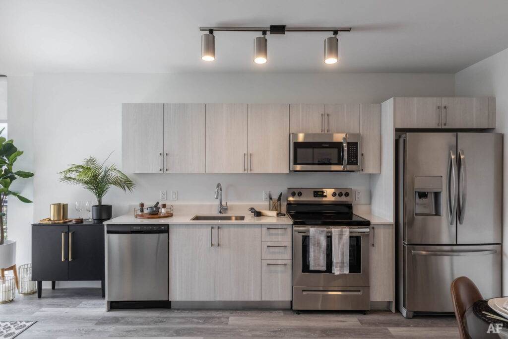 Modern kitchen with stainless steel appliances and sleek cabinetry.
