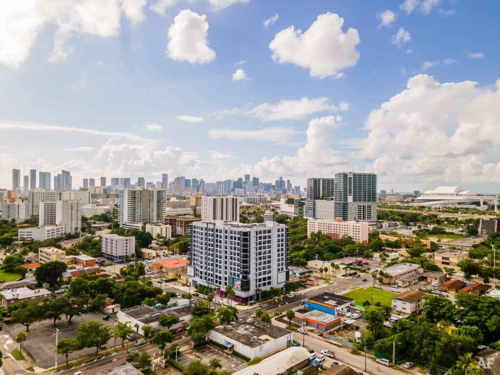 Aerial view of the vibrant cityscape with modern buildings against a blue sky.