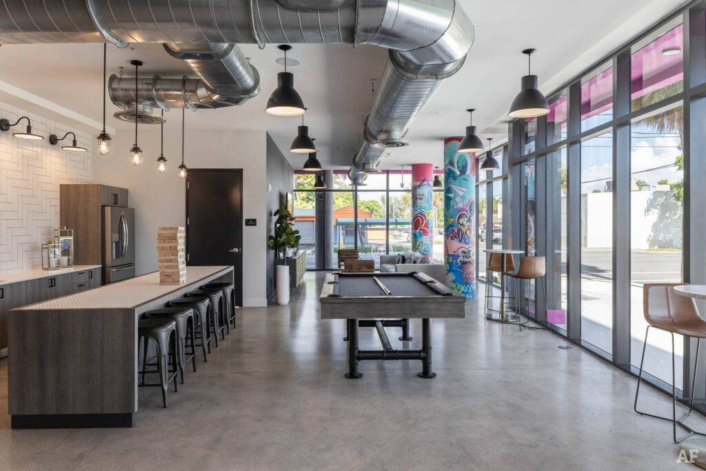 Modern industrial kitchen with bar seating and art-filled walls