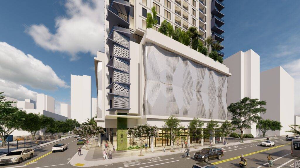 Modern high-rise building with a textured facade and urban landscaping on a bustling city street corner.