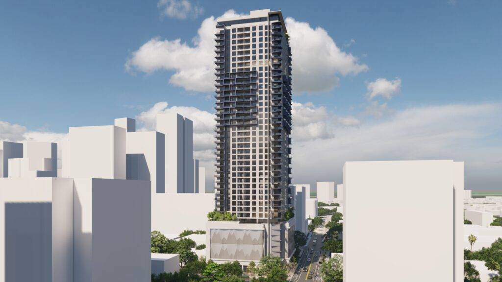 Modern skyscraper in a cityscape with blue sky and clouds.