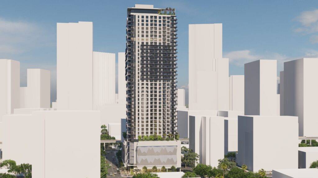 Modern skyscraper amid urban skyline on a sunny day.