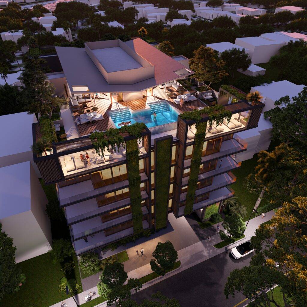 Aerial view of a luxurious modern apartment building with a rooftop pool and lush greenery at night.