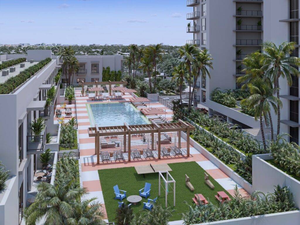 Rooftop pool area with stylish lounging spaces and lush greenery at a modern apartment complex