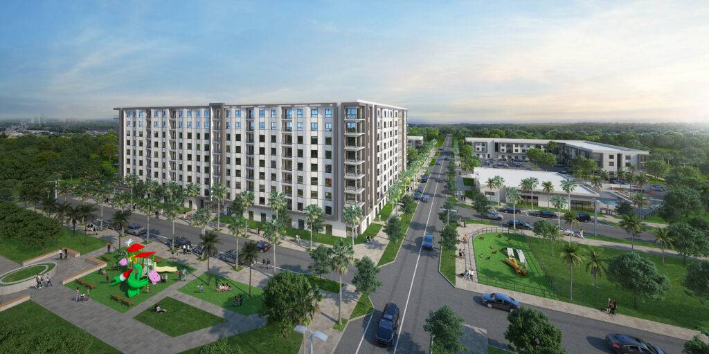 Aerial view of a modern residential building surrounded by green parks and vibrant city streets.