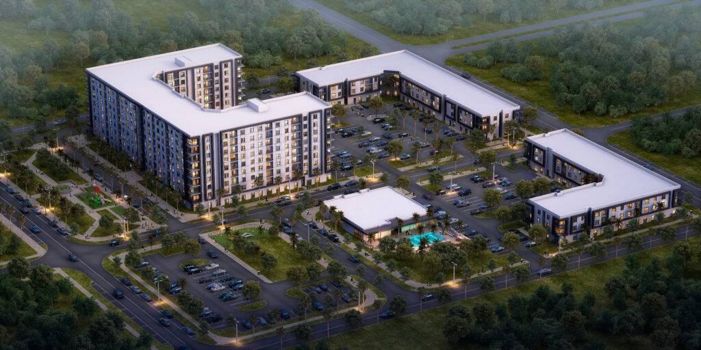 Aerial view of a modern apartment complex surrounded by lush greenery and intersecting roads.