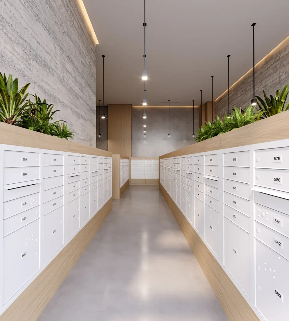Modern hallway with sleek white mailboxes and ceiling lights, accented by lush green plants.