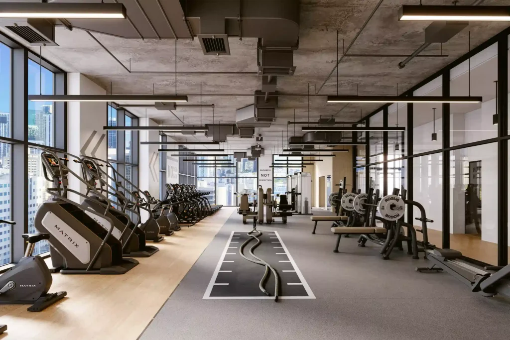 Modern fitness center with cardio and strength equipment in a spacious urban setting