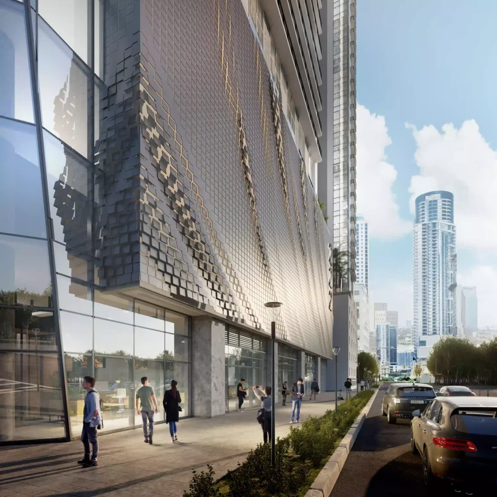 Modern skyscraper facade with reflective glass and city street.
