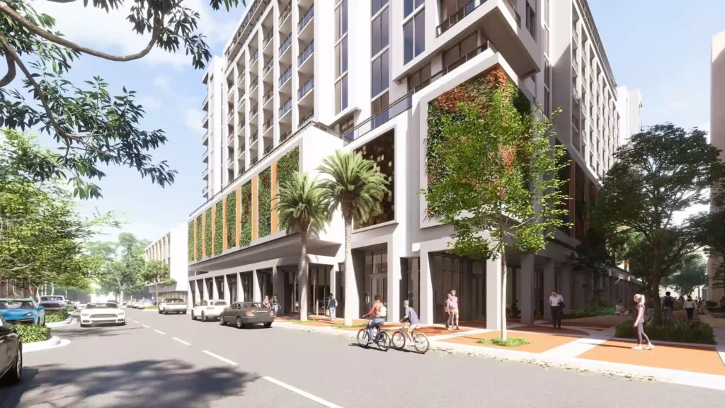 Modern urban building with green facades and street-level activity in a vibrant neighborhood.