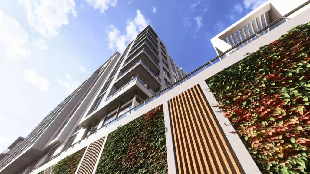 Modern high-rise building with lush vertical gardens under a clear blue sky.