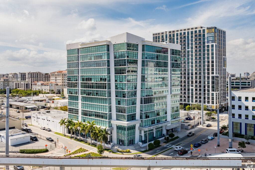 Modern office building in Coral Gables with cityscape background.