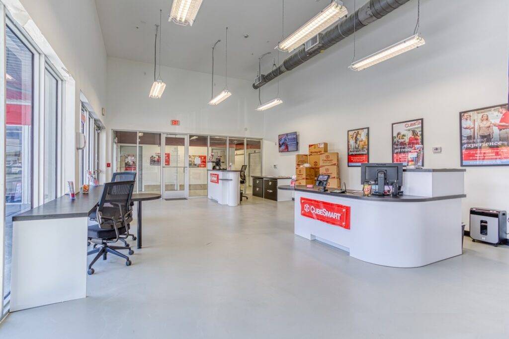 Modern interior of a bright office with sleek furniture and large windows.