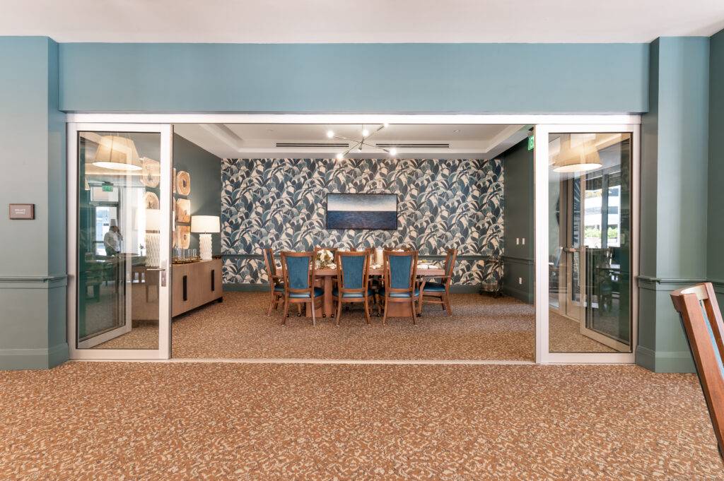 Elegant private dining room with floral wallpaper and wooden furniture in Coral Gables.