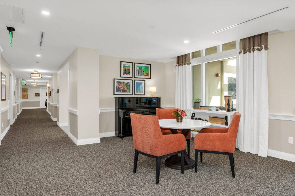 Elegant seating area in a modern lobby with framed artwork and soft lighting.