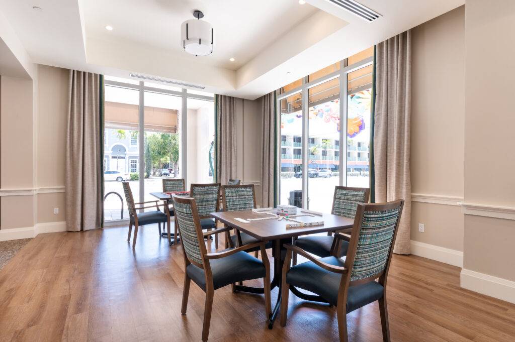 Elegant dining area with wooden floors and large windows in Coral Gables.
