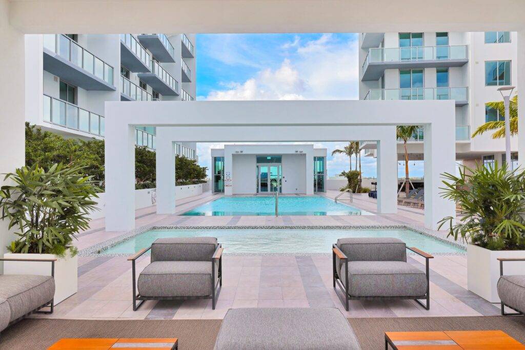 Luxurious poolside area with modern architecture and outdoor seating.