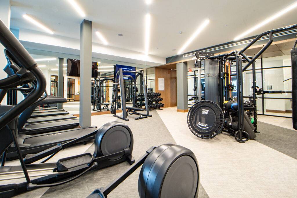 Modern gym interior featuring state-of-the-art fitness equipment and sleek design.