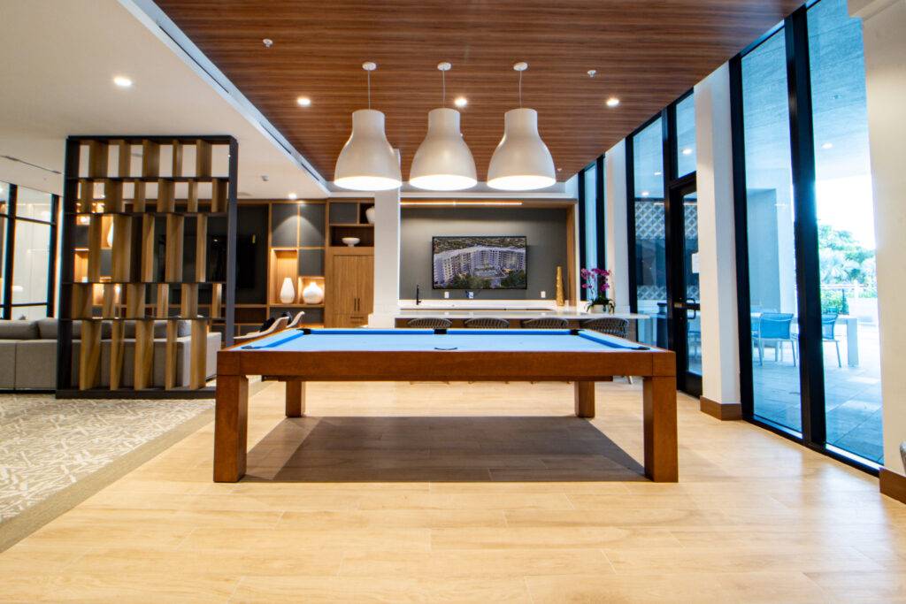 Modern recreation room with a sleek billiards table and stylish lighting