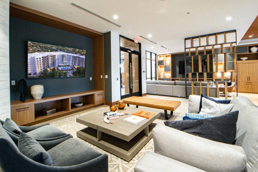 Modern living room with cozy seating, a large TV, and elegant decor.