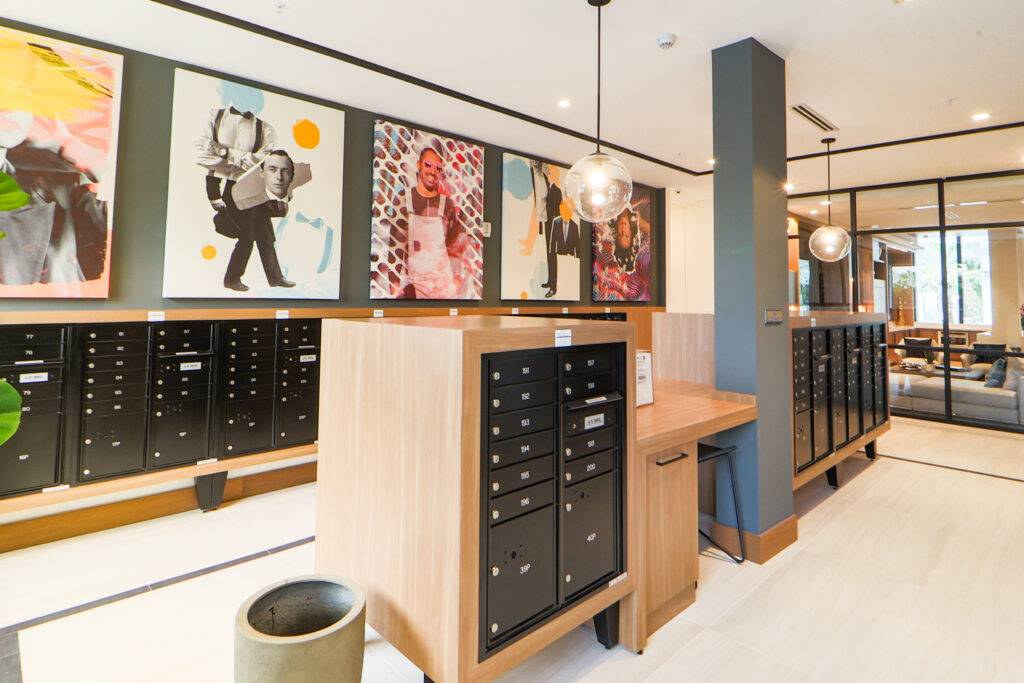 Modern art gallery with contemporary paintings and stylish wooden displays.