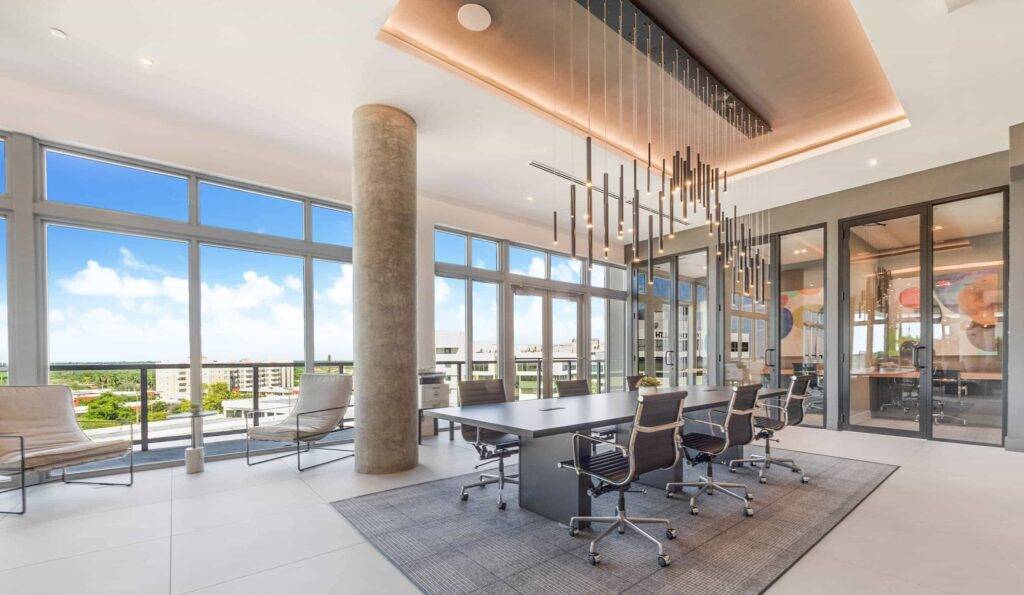 Modern conference room with panoramic city views and elegant lighting.