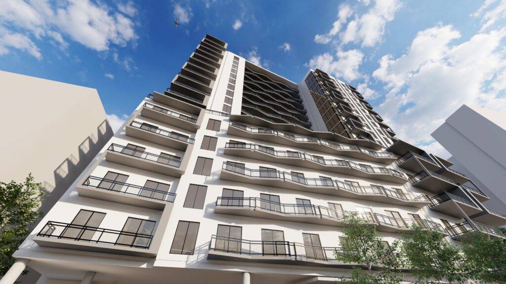 Modern high-rise building with balconies against a blue sky.
