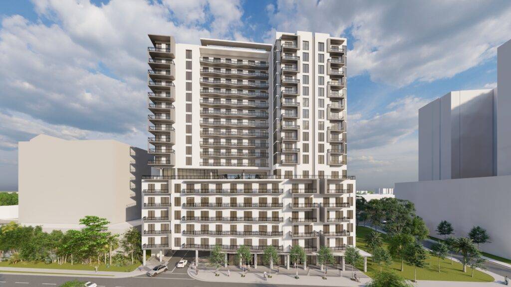 Modern high-rise building against a blue sky with clouds.