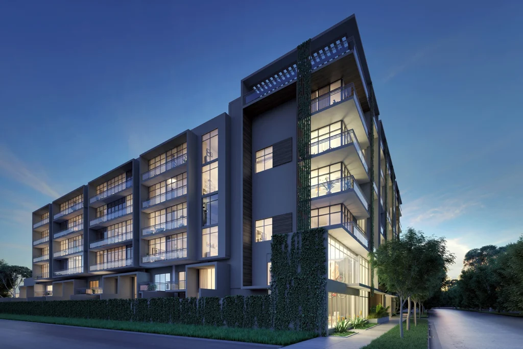 Modern apartment building with illuminated windows at dusk