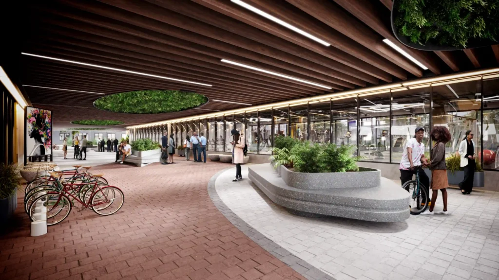 Modern underground space with greenery, benches, and people walking or cycling.