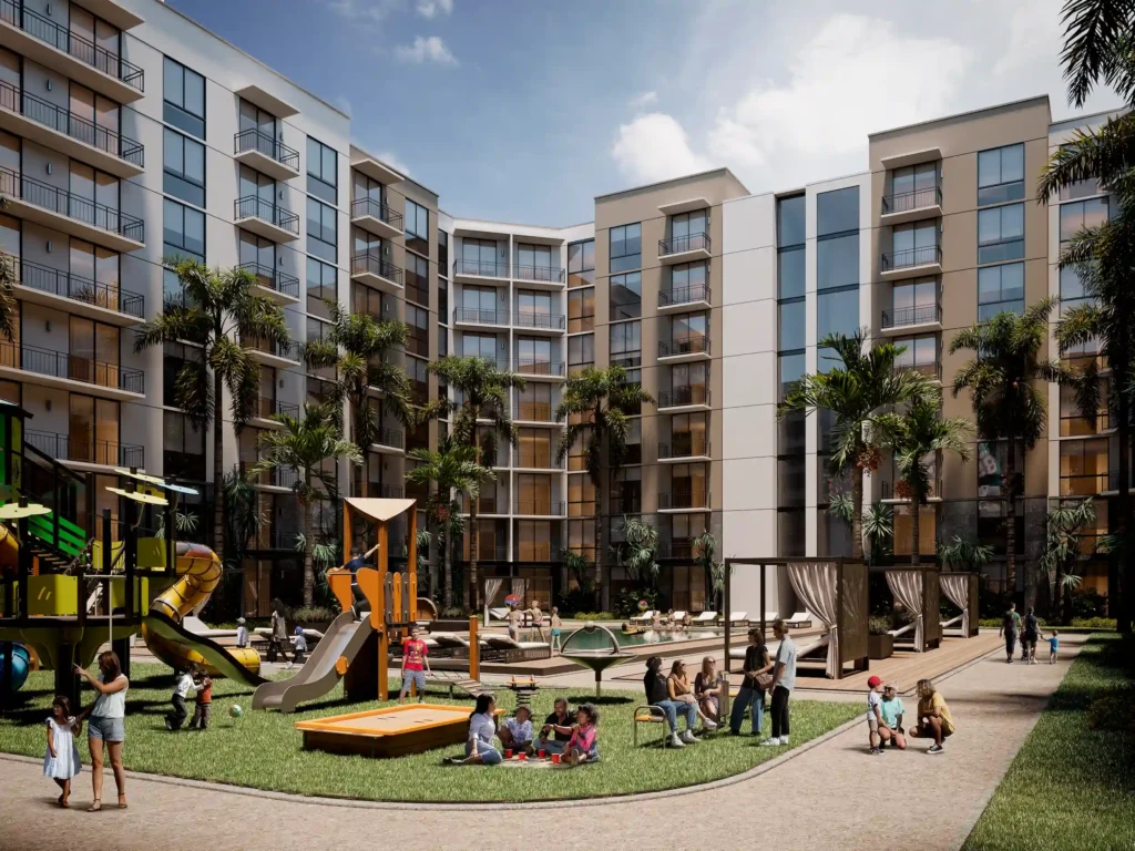 Modern apartment complex with a vibrant playground and palm trees in the courtyard.