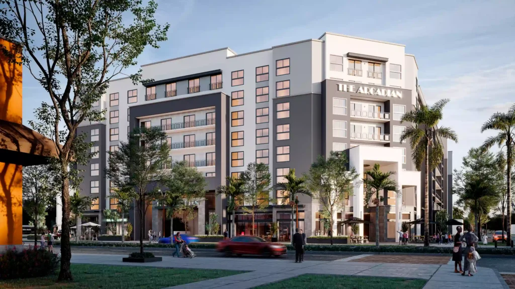 Modern urban apartment building surrounded by trees and palm trees, with pedestrians and a red car in the foreground.