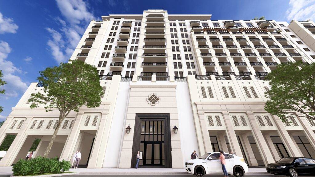Modern high-rise building against a blue sky with clouds.