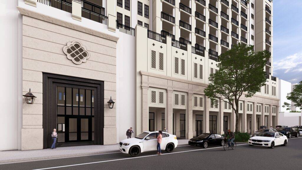 Modern urban building with elegant facade, parked cars, and people on the sidewalk.