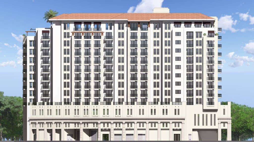Modern multi-story building with a classic design, featuring white facades, balconies, and a red-tiled roof against a clear blue sky.
