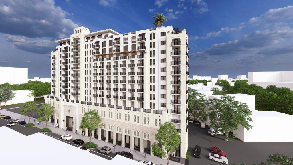 Modern white apartment building with balconies under a blue sky.