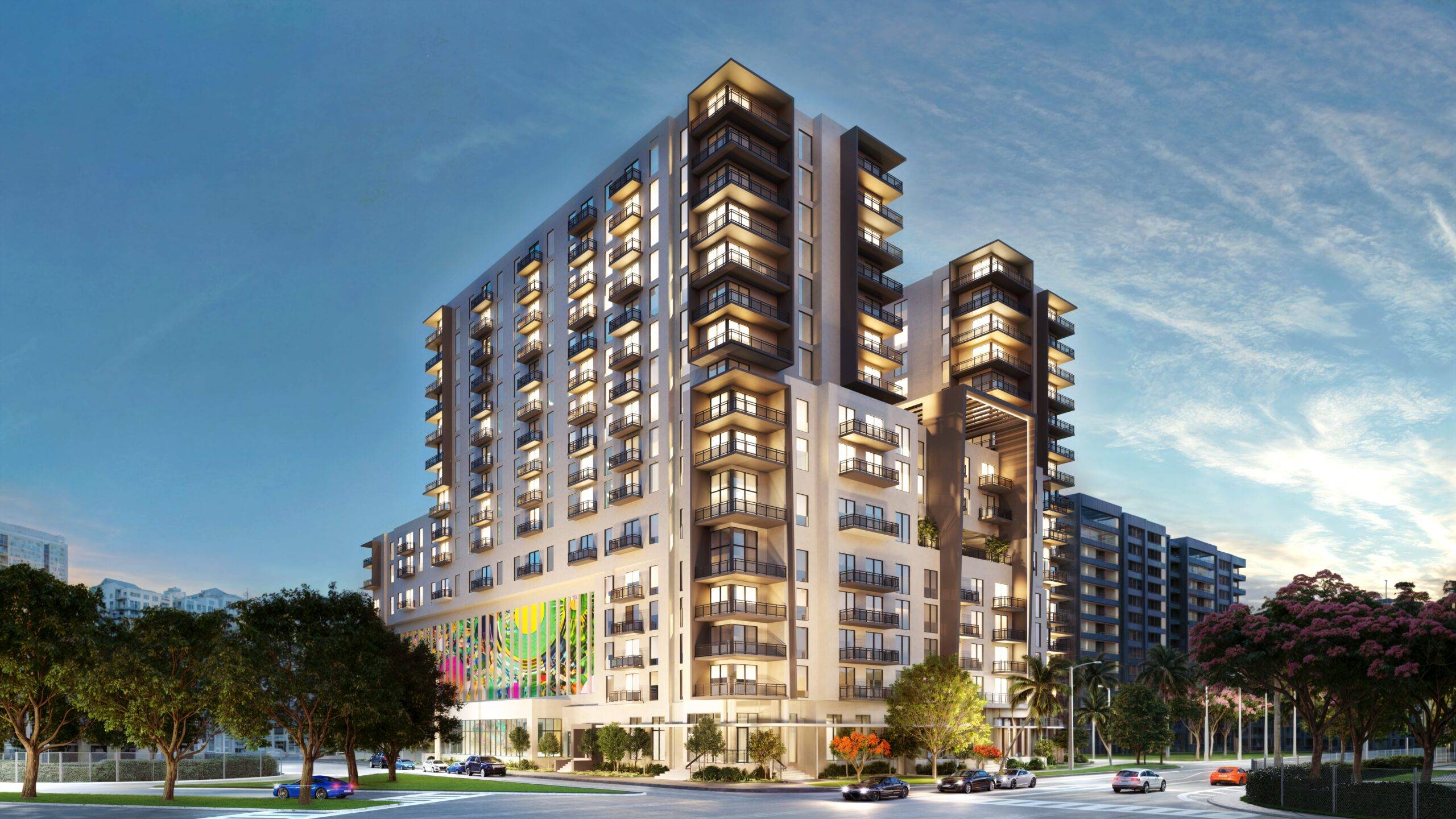 Modern multi-story apartment building with illuminated windows at dusk.