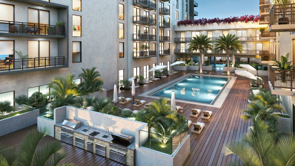 Luxury apartment complex with a pool, surrounded by palm trees and outdoor lounges.