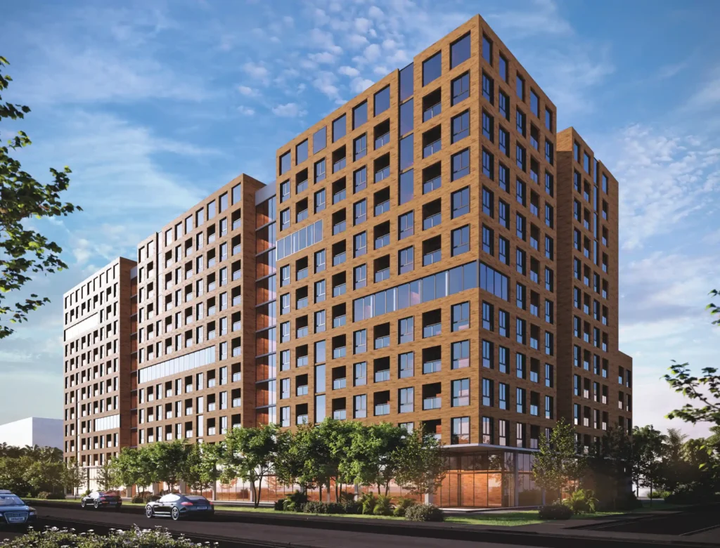 Modern residential building with a unique design, featuring large windows and surrounded by greenery.