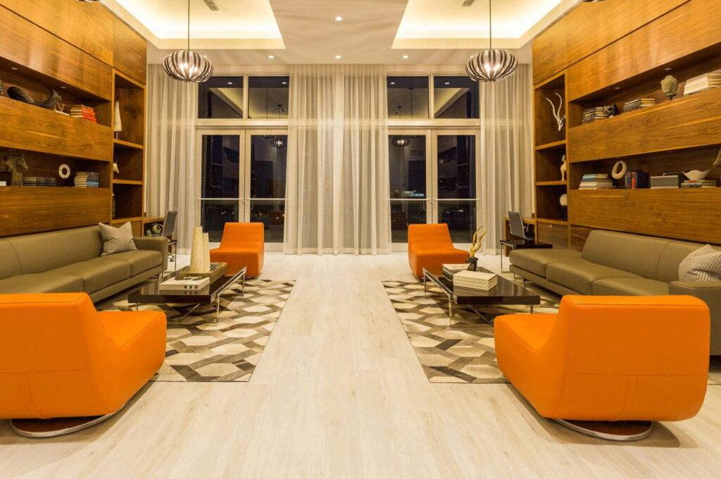 Modern living room with orange chairs and wooden shelves