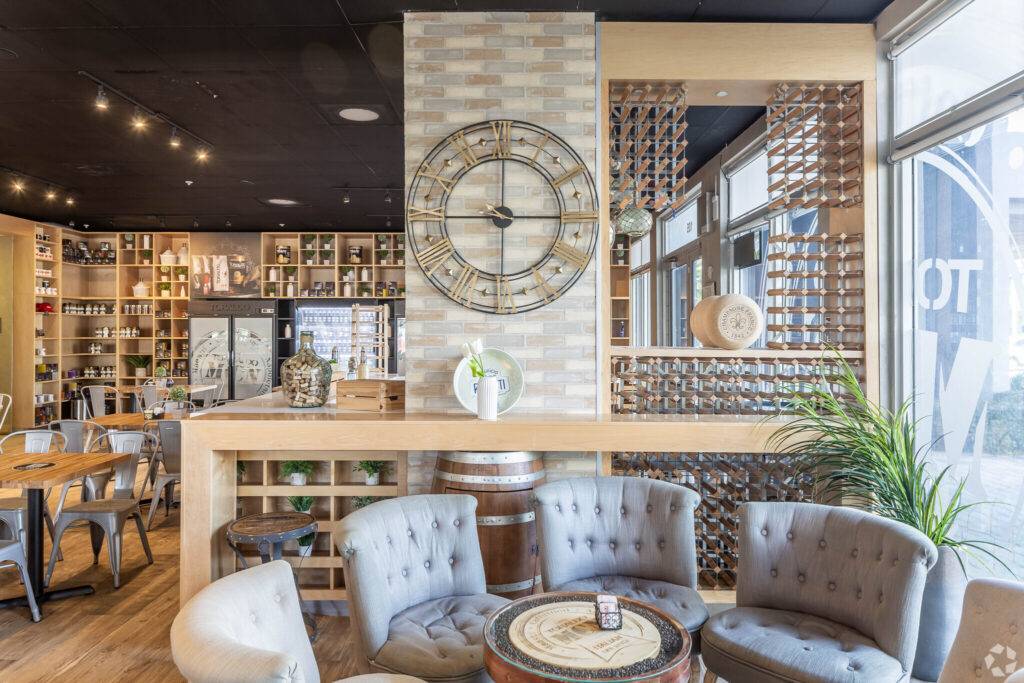 Cozy restaurant interior with vintage decor and a large wall clock.