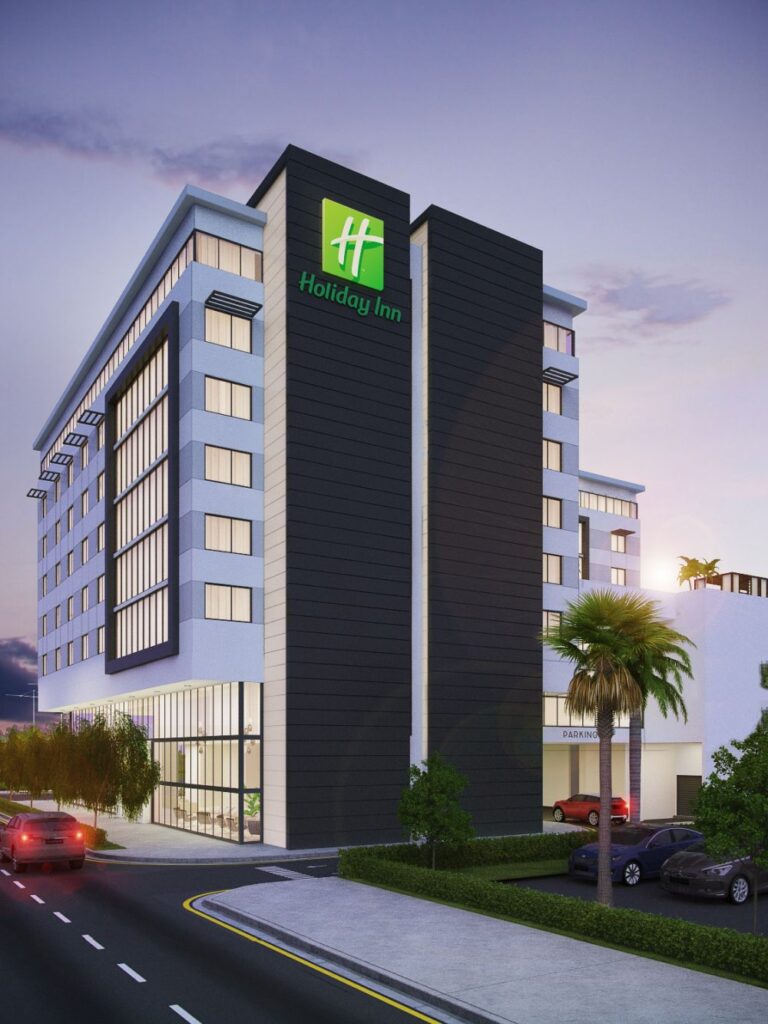 Modern Holiday Inn Fort Lauderdale exterior with sleek design and palm trees at dusk.